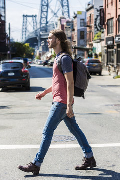 USA, New York City, man crossing the street in Williamsburg, Brooklyn