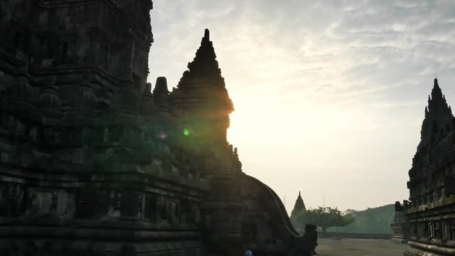 Beautiful silhouettes of Prambanan temple with bright sun light shining over ancient hindu complex in cental Java, Indonesia