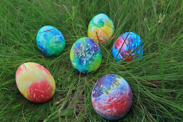 Colorful Easter eggs on green grass