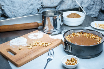 Cake making. Cooking concept. Professional confectioner decorating tasty cake with chocolate frosting