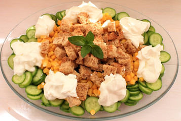 Salad with vegetables, herbs, corn, bread crustons and yogurt