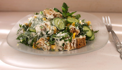 Salad with vegetables, herbs, corn, bread crustons and yogurt