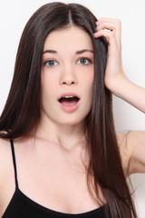 Young beautiful teen girl with long hair and scared expression