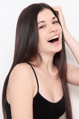 Young beautiful healthy laughing teen girl with long hair