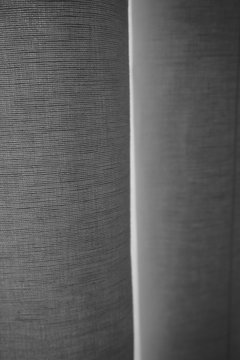abstract light behind linen curtain black/white