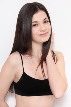 Young beautiful slim smiling teen girl with long hair and clean make-up