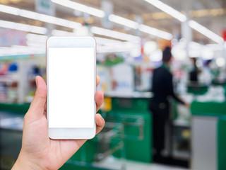 supermarket checkout cashier counter with hand hold mobile smartphone