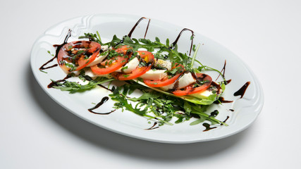 Mozzarella with tomatoes flavored balsamic, olive oil