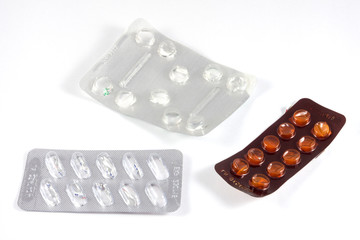 Three empty blister packs for tablet and capsule. They are isolated on white background.