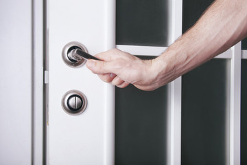 hand turns the doorknob, opens the door