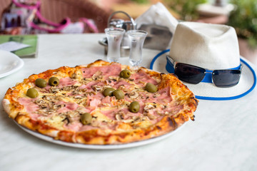 Pizza Margherita on white tablecloth closeup shot 