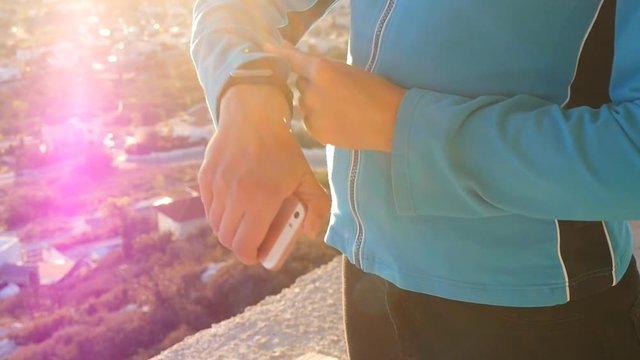 Fitness woman looking at smartwatch outdoor