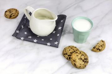 Chocolate chips cookies with milk glass and jar