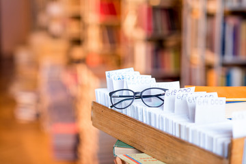 Card catalogue with eyeglasses at the library. Image with copy space