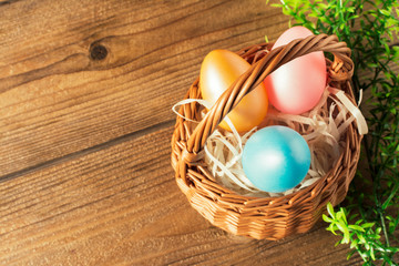 Basket of easter eggs on wooden table