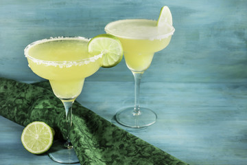 Lemon Margarita cocktails with limes and copyspace