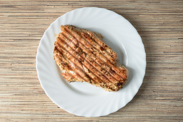 Grilled chicken schnitzel  / Grilled chicken schnitzel on white plate