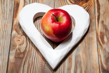 Ripe red apples on a wooden background. Top view. Vegan concept.