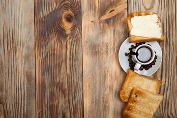 Breakfast, toast and coffee on a wooden background