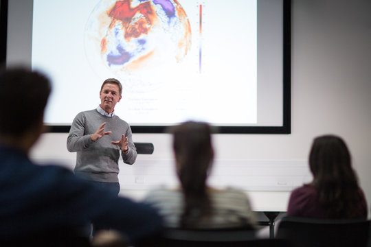 Teacher giving lecture at college