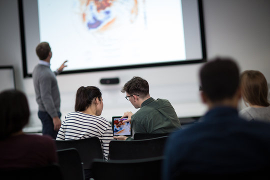 Students using digital tablet at a lecture
