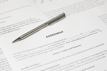 Contract papers with a pen on the table. The documents is ready to be filled out.