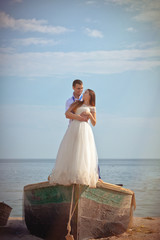 Fototapeta na wymiar Wedding couple in a boat on the beach