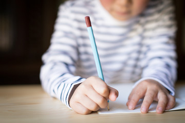 boy studying or doing home work, close up