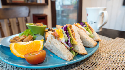 Closeup club sandwich on blue dish 2