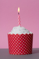 red cupcake with candle