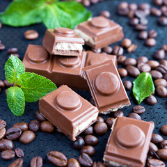 Chocolate and coffee beans and mint on a dark background