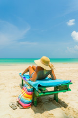 Woman sitting on a chair at the beach