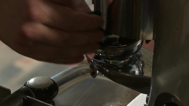 Making coffee in electric coffe machine in a cafe