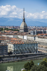 Panoramic view of Turin city center, in Italy, in a sunny day, with Mole Antonelliana and Alps in the background