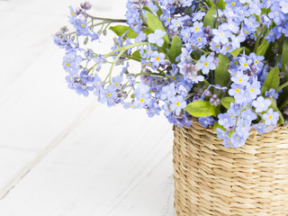 blue flowers bouquet on white wooden background