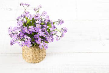 blue flowers bouquet on white wooden background