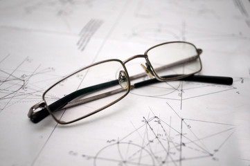 Student glasses left on plans for construction