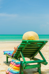 Woman sitting on a chair at the beach