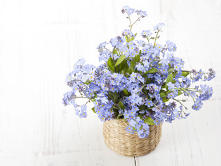 blue flowers bouquet on white wooden background