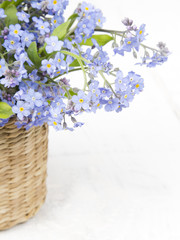 blue flowers bouquet on white wooden background
