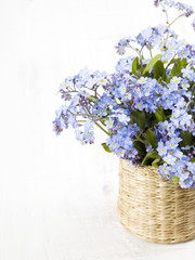 blue flowers bouquet on white wooden background