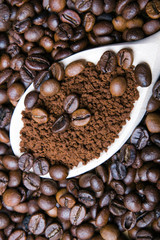 Iinstant coffee in spoon on coffee beans background