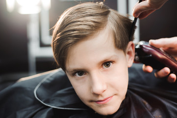 Fototapeta premium cute young boy getting a haircut