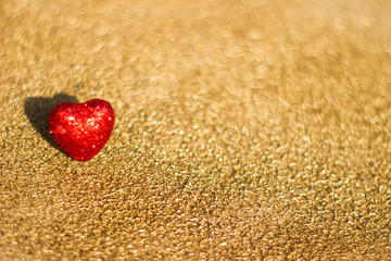 Fototapeta premium Red heart on a gold background, abstract
