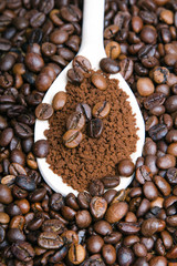 Iinstant coffee in spoon on coffee beans background