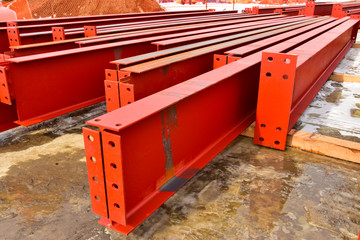 Rows of steel I beams ready for installation at nearby construction site.