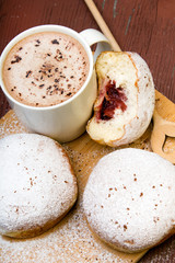 Classic donuts with powdered sugar, on wooden background