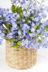 blue flowers bouquet on white wooden background