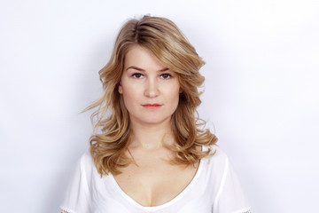 Fototapeta premium Pretty blonde young woman with curly long hair
