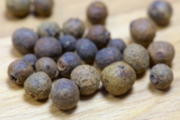 macro allspice on wooden background.